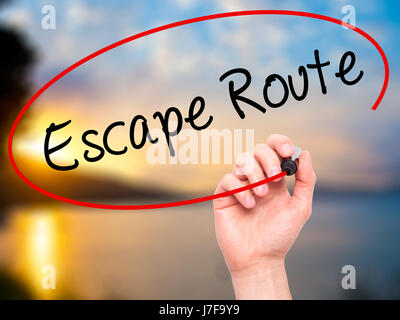 Man Hand writing Escape Route with black marker on visual screen. Isolated on nature. Business, technology, internet concept. Stock Photo Stock Photo