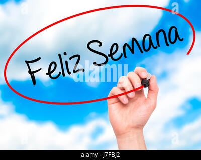 Man Hand writing Feliz Semana  (Happy Week in Spanish/Portuguese) with black marker on visual screen. Isolated on background. Business, technology, in Stock Photo