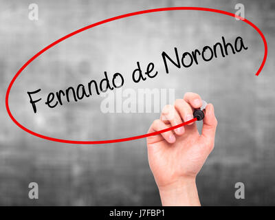 Man Hand writing Fernando de Noronha with black marker on visual screen. Isolated on grey. Business, technology, internet concept. Stock Photo Stock Photo
