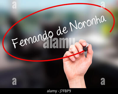 Man Hand writing Fernando de Noronha with black marker on visual screen. Isolated on office. Business, technology, internet concept. Stock Photo Stock Photo