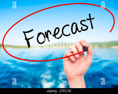 Man Hand writing Forecast with black marker on visual screen. Isolated on nature. Business, technology, internet concept. Stock Photo Stock Photo