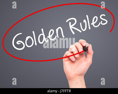 Man Hand writing Golden Rules with black marker on visual screen ...