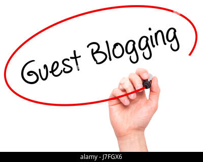 Man Hand writing Guest Blogging  with black marker on visual screen. Isolated on white. Business, technology, internet concept. Stock Photo Stock Photo