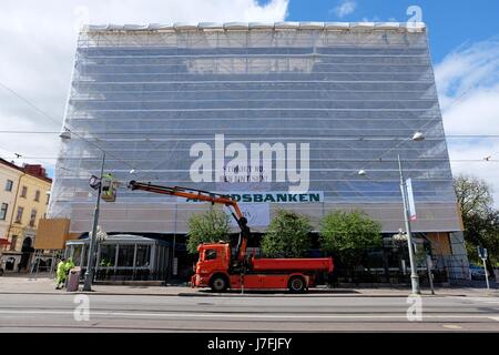 Gothenburg, Sweden - May, 2017: Building in scaffolding under construction and workers in Gothenburg, Sweden. Stock Photo
