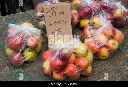 Plastic bags of apples for sale at the Union Square Greenmarket in New York City, $3.00 a bag, $5.00 for two Stock Photo