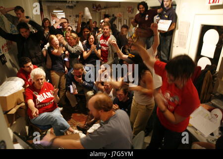 Volunteers cheer at Barack Obama's headquarters in Bloomington, Indiana on November 4, 2008 - election night - as television news announces a small lead for Obama again McCain at the moment in this photograph. Stock Photo