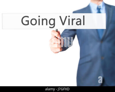 Going Viral - Businessman hand holding sign. Business, technology, internet concept. Stock Photo Stock Photo