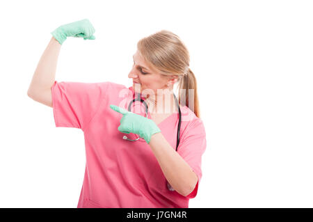 Female medical nurse showing her biceps wearing pink scrubs isolated on white background with copy text space Stock Photo