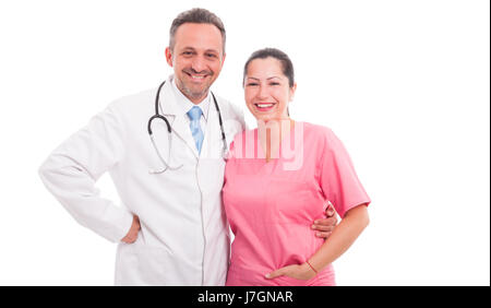 Confident medical team standing next to each other and smiling cheerfully on white studio background Stock Photo