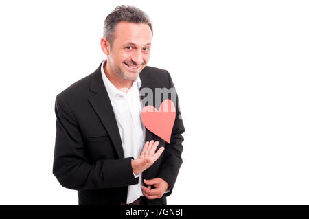 Happy man carries red heart shaped card isolated on white as passion concept with copyspace Stock Photo