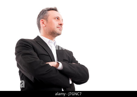 Confident man in formalwear keeping his arms crossed and looking one side in low angle shot with copyspace Stock Photo