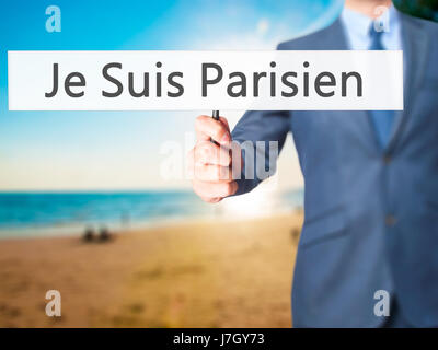 Je Suis Parisien ( I am Parisien)  - Businessman hand holding sign. Business, technology, internet concept. Stock Photo Stock Photo