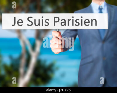 Je Suis Parisien ( I am Parisien)  - Businessman hand holding sign. Business, technology, internet concept. Stock Photo Stock Photo