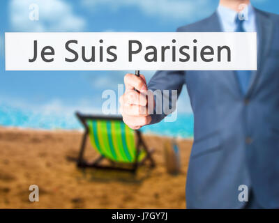 Je Suis Parisien ( I am Parisien)  - Businessman hand holding sign. Business, technology, internet concept. Stock Photo Stock Photo