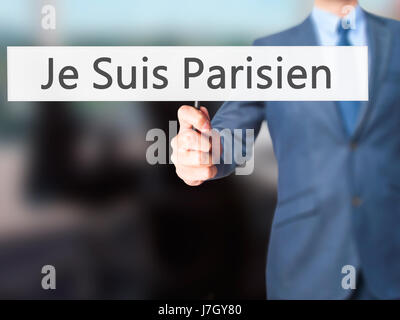 Je Suis Parisien ( I am Parisien)  - Businessman hand holding sign. Business, technology, internet concept. Stock Photo Stock Photo