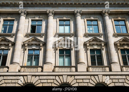 Windows on historic building facade with columns Stock Photo