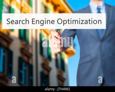 Search Engine Optimization - Business man showing sign. Business, technology, internet concept. Stock Photo Stock Photo