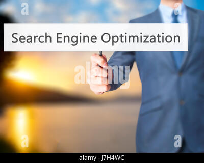Search Engine Optimization - Business man showing sign. Business, technology, internet concept. Stock Photo Stock Photo
