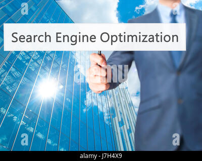 Search Engine Optimization - Business man showing sign. Business, technology, internet concept. Stock Photo Stock Photo