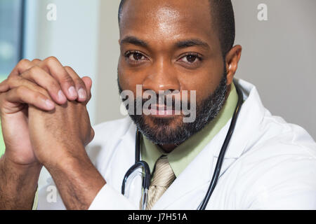 An African American doctor in a white lab coat with a stethoscope Stock Photo