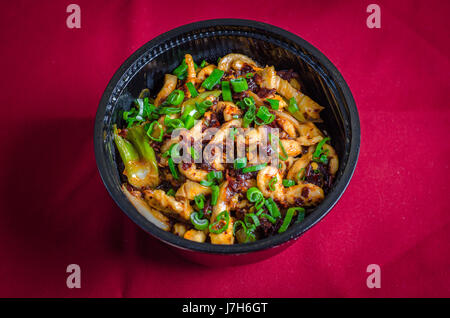 a bowl of shredded pork on a red background Stock Photo