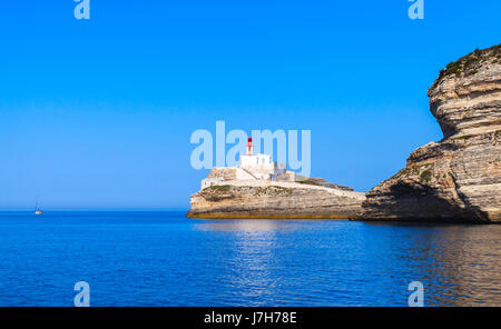 Madonetta, lighthouse tower with red top. Entrance to Bonifacio port. Mountainous Mediterranean island Corsica, Corse-du-Sud, France Stock Photo