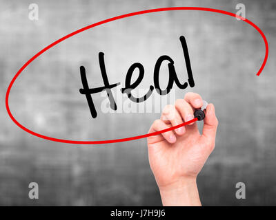 Man Hand writing Heal with black marker on visual screen. Isolated on ...