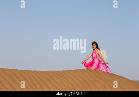 young woman with angle wings in a desert Stock Photo