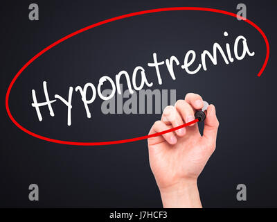 Man Hand writing Hyponatremia  with black marker on visual screen. Isolated on background. Business, technology, internet concept. Stock Photo Stock Photo