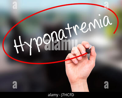 Man Hand writing Hyponatremia  with black marker on visual screen. Isolated on background. Business, technology, internet concept. Stock Photo Stock Photo