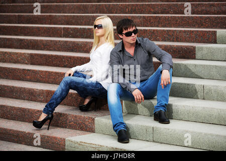 Young couple in conflict sitting on the steps Stock Photo