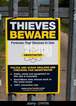 Smartwater Thieves beware forensic trap device in use sign on gate to rural agricultural land Stock Photo