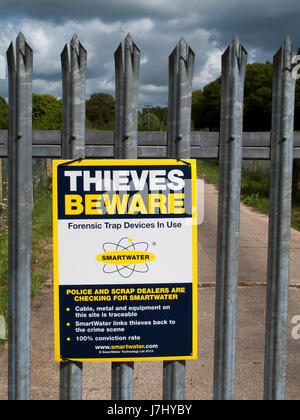 Smartwater Thieves beware forensic trap device in use sign on gate to rural agricultural land Stock Photo