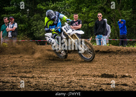 Uzhgorod, Ukraine - May 21, 2017: Enduro bike rider accelerating in dirt track.  TransCarpathian regional Motocross Championship Stock Photo