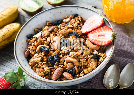 Granola with dried fruits and nuts in bowl. Concept of healthy eating, dieting. Closeup view Stock Photo