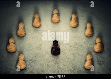 Black chess pawn piece surrounded by white ones joining their power together. Business group leadership and team working symbol. Racism or bullying.