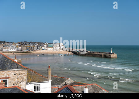 View over tiled roof tops of St Ives harbour and the sea Stock Photo