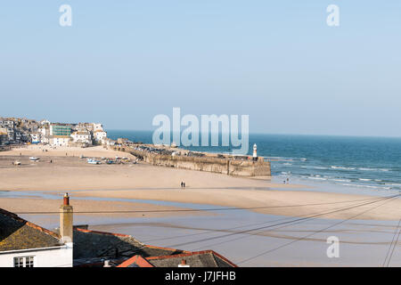 View over tiled roof tops of St Ives harbour and the sea Stock Photo