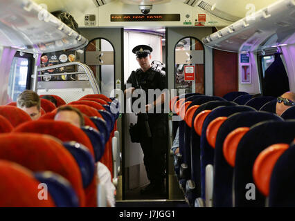 Armed British Transport Police Specialist Operations officers on board a Virgin train to Birmingham New Street at Euston station in London as armed police officers are patrolling on board trains nationwide for the first time. Stock Photo