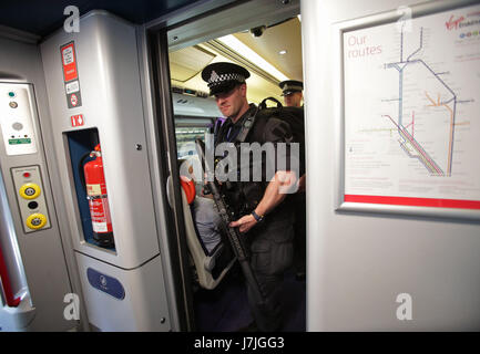 Armed British Transport Police Specialist Operations officers on board a Virgin train to Birmingham New Street at Euston station in London as armed police officers are patrolling on board trains nationwide for the first time. Stock Photo