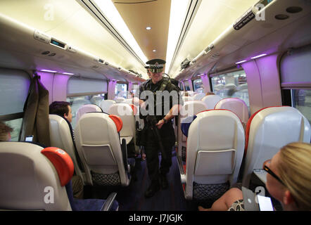 Armed British Transport Police Specialist Operations officers on board a Virgin train to Birmingham New Street at Euston station in London as armed police officers are patrolling on board trains nationwide for the first time. Stock Photo