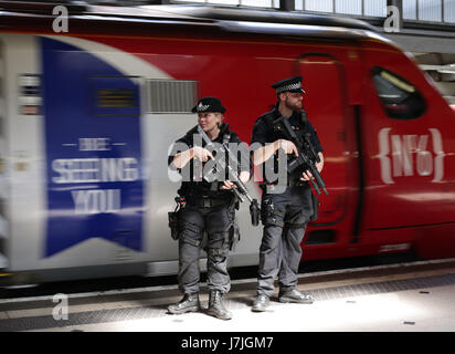 Armed British Transport Police Specialist Operations officers on the platform before boarding a Virgin train to Birmingham New Street at Euston station in London as armed police officers are patrolling on board trains nationwide for the first time. Stock Photo