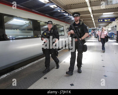 Armed British Transport Police Specialist Operations officers on the platform before boarding a Virgin train to Birmingham New Street at Euston station in London as armed police officers are patrolling on board trains nationwide for the first time. Stock Photo