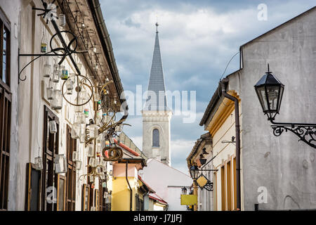 Hrnciarska street with Calvinist church in Kosice, Slovak republic. Folk art theme. Religious architecture. Stock Photo