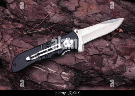 Pocket knife in unfolded form with a clip. A sharp knife. Stock Photo