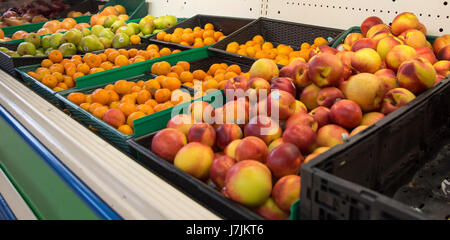 Local asian grocer has aisle of packaged foods, various fruits, meats, and colourful sweet treats. A local store providing foods from other countries. Stock Photo