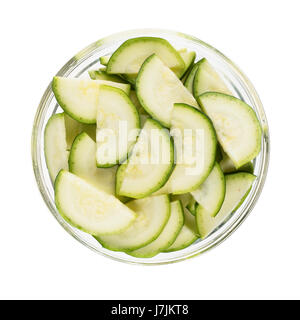 Half zucchini slices in glass bow and isolated on white background Stock Photo
