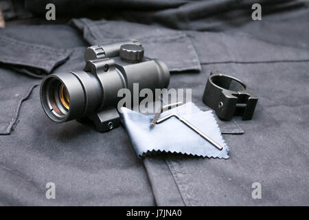Sight for tactical weapons. Collimator sight. Black background. Stock Photo