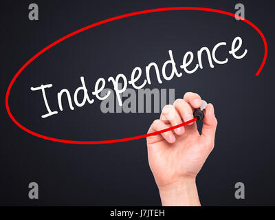 Man Hand writing Independence  with black marker on visual screen. Isolated on background. Business, technology, internet concept. Stock  Photo Stock Photo