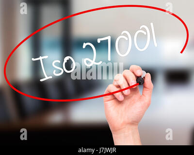Man Hand writing Iso 27001  with black marker on visual screen. Isolated on office. Business, technology, internet concept. Stock Photo Stock Photo